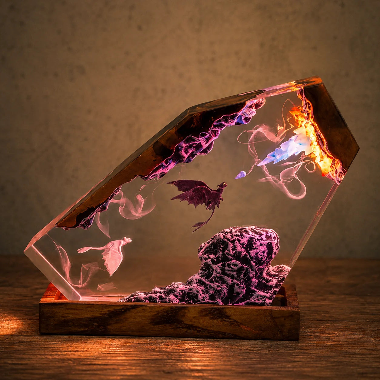 A hexagonal clear resin crystal lamp on a wooden base, glowing with purple, pink, orange, and blue internal lights and featuring a dragon and cloud-like swirls inside.